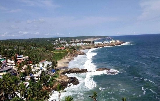Kovalam beach with lighthouse and palm trees